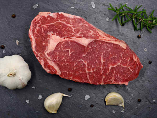 Easy Ribeye Steak Recipe: Delicious and Quick to Make 3 Raw ribeye cut with garlic and herbs