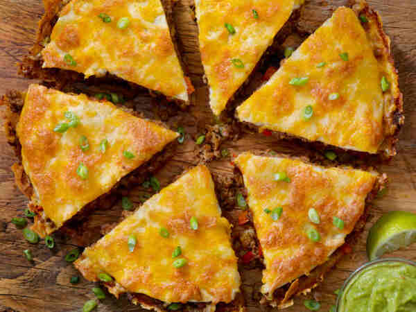 Taco Pie: A Tasty Twist on a Classic Favorite 6 Sliced taco pie with guacamole and lime
