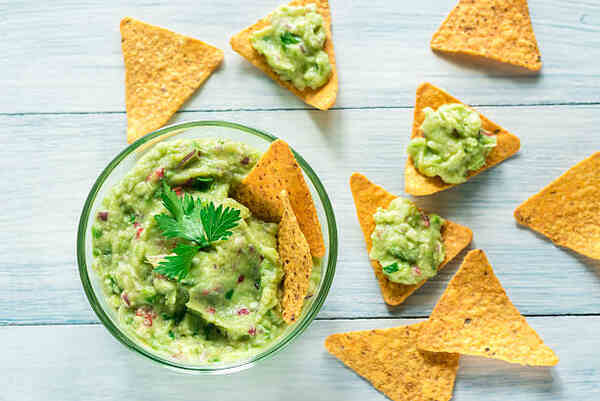 Low-Carb Tortilla Chips to Buy: Top Picks for Dieters 3 Tortilla chips with guacamole dip in a bowl