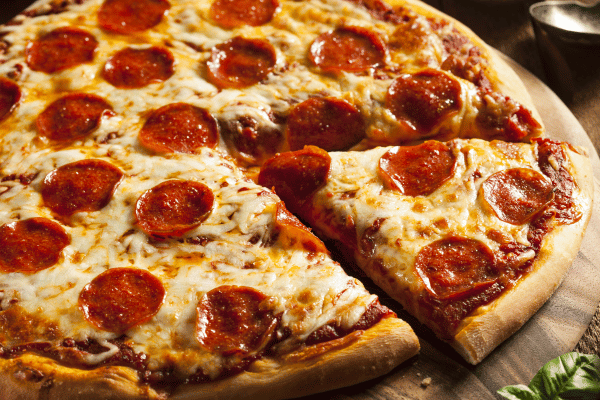 Totino's Pizza Air Fryer Style - Perfectly Crispy and Easy 10 A delicious sliced pizza topped with melted cheese and pepperoni, ready to be enjoyed.