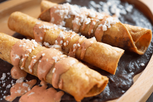 Jose Ole Taquitos Air Fryer: A Step-by-Step Cooking Tutorial 11 Taquitos topped with flavorful sauces, ready to enjoy!