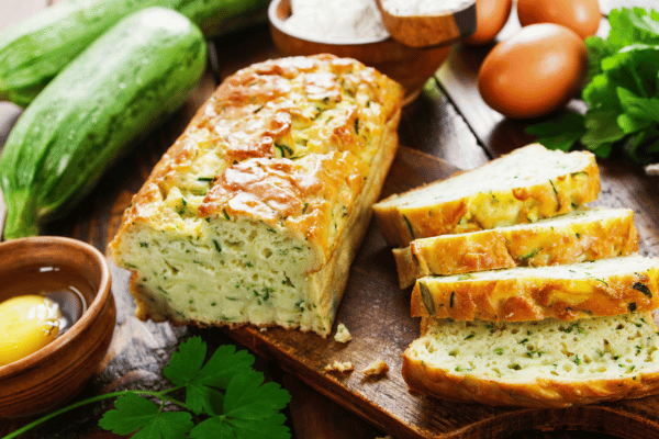 Carb Free Bread Recipe: A Simple Guide for Beginners 15 A loaf of zucchini bread, sliced to reveal its moist, dense texture, shows flecks of green from the zucchini throughout.