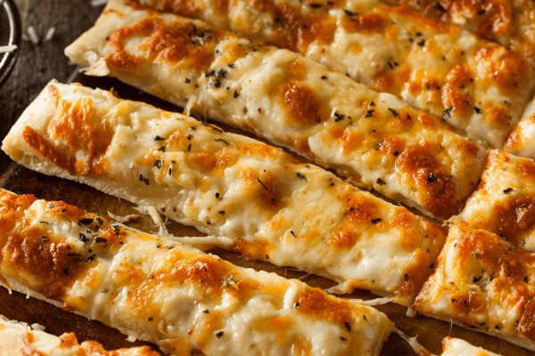 Carb Free Bread Recipe: A Simple Guide for Beginners 16 A close-up of cheesy garlic breadsticks reveals the gooey melted cheese on top.