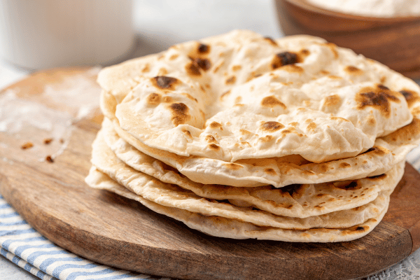 Carb Free Bread Recipe: A Simple Guide for Beginners 17 A stack of coconut flour flatbreads sits neatly on a plate.
