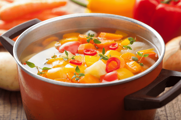 Keto Vegetable Soup: The Ultimate Low-Carb Option for Every Season 5 A close-up view of a pot filled with a hearty vegetable soup, showcasing chunks of carrots, potatoes, and other colorful veggies.