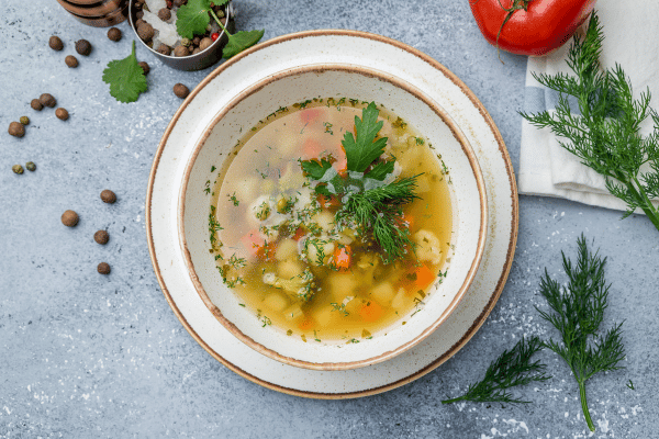Keto Vegetable Soup: The Ultimate Low-Carb Option for Every Season 6 A top view of a beautifully presented bowl of keto vegetable soup, featuring a vibrant mix of veggies, garnished with fresh herbs and a sprinkle of spices.