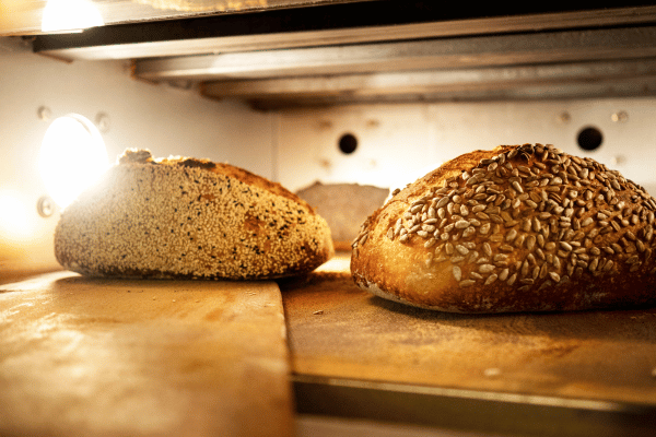 Carb Free Bread Recipe: A Simple Guide for Beginners 7 A person peeks into the oven, checking on the low-carb bread as it bakes.