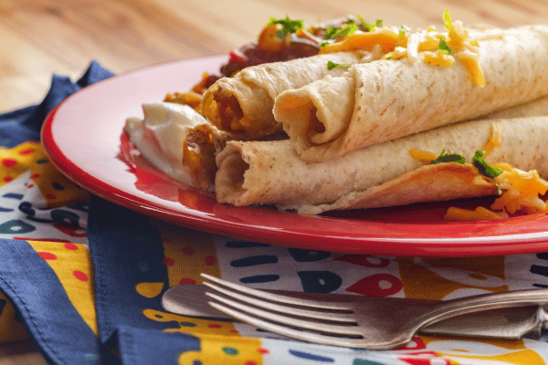 Jose Ole Taquitos Air Fryer: A Step-by-Step Cooking Tutorial 7 Jose Ole Taquitos Air Fryer: Taquitos drizzled with sauce, served on a plate for a delicious treat!