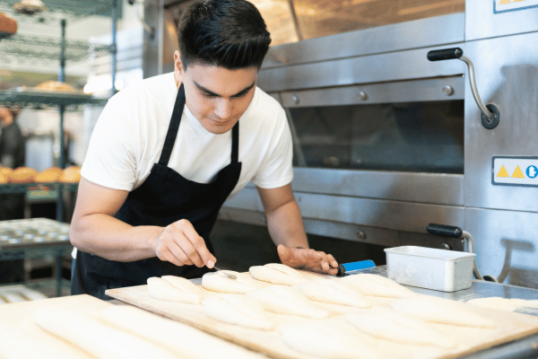Carb Free Bread Recipe: A Simple Guide for Beginners 9 A person prepares bread by mixing ingredients in a bowl.