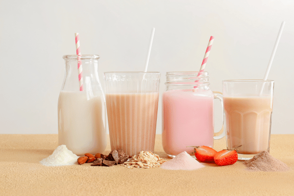 How Low Carb Protein Shakes Can Boost Your Fitness Goals 9 A variety of glasses each hold different types of protein shakes.