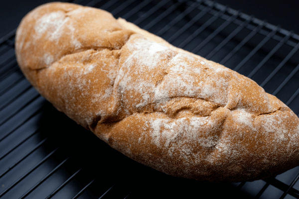 Carb Free Bread Recipe: A Simple Guide for Beginners 10 A freshly baked loaf of low-carb bread rests on the counter, golden and warm, cooling in its pan.