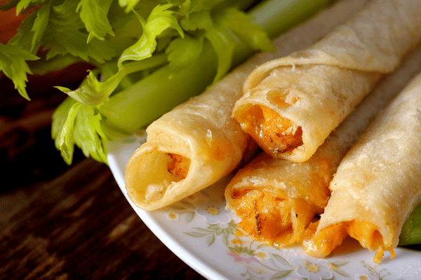 Jose Ole Taquitos Air Fryer: A Step-by-Step Cooking Tutorial 10 Jose Ole Taquitos Air Fryer: Taquitos with delicious sauce, served on a plate with fresh celery.