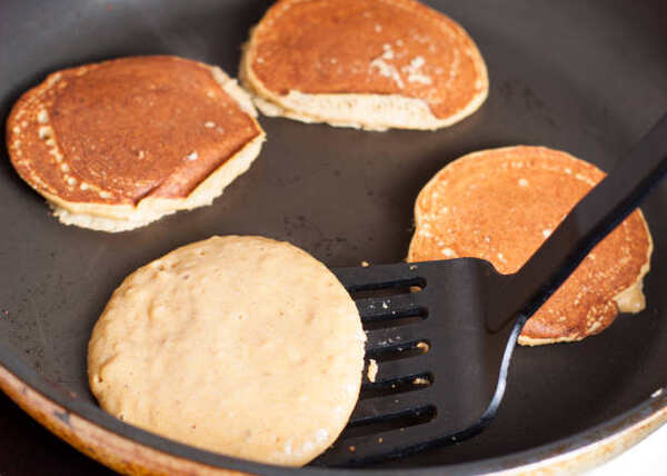 Fluffy Keto Pancakes: Low-Carb Breakfast You’ll Love 6 Flipping pancakes on a pan