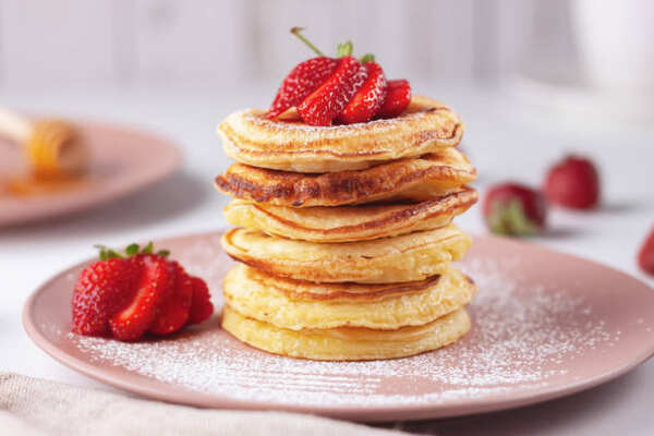 Fluffy Keto Pancakes: Low-Carb Breakfast You’ll Love 9 A stack of fluffy pancakes topped with strawberries