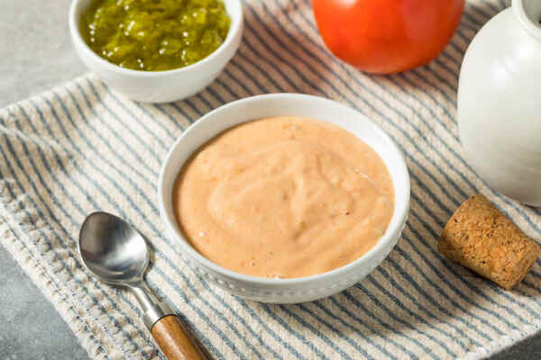 Keto Thousand Island Dressing Perfect for Low-Carb Salads 6 Thousand Island dressing in a bowl with pickles and tomato