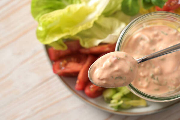 Keto Thousand Island Dressing Perfect for Low-Carb Salads 2 Homemade Thousand Island dressing in a bowl with lettuce and tomatoes