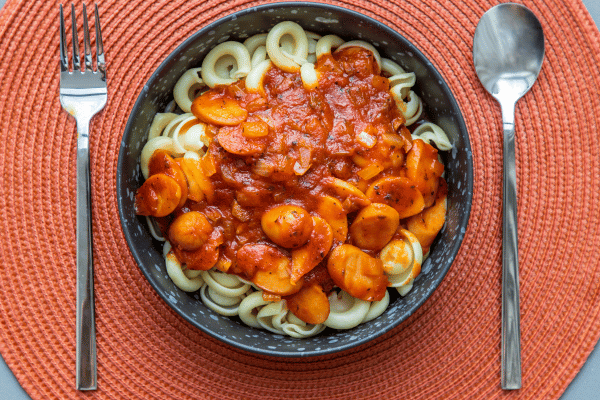 The Best Keto Pasta to Satisfy Your Carb Cravings 9 A top view of a low-carb Bolognese dish featuring Palmini noodles or spaghetti squash.