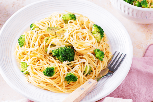 The Best Keto Pasta to Satisfy Your Carb Cravings 11 A plate of keto noodles paired with vibrant green broccoli florets.