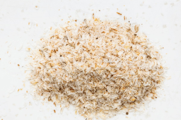 Is Buckwheat Keto Friendly? Everything You Need to Know 13 Psyllium husk sits on a white table, its light, fibrous texture resembling tiny, thin flakes.
