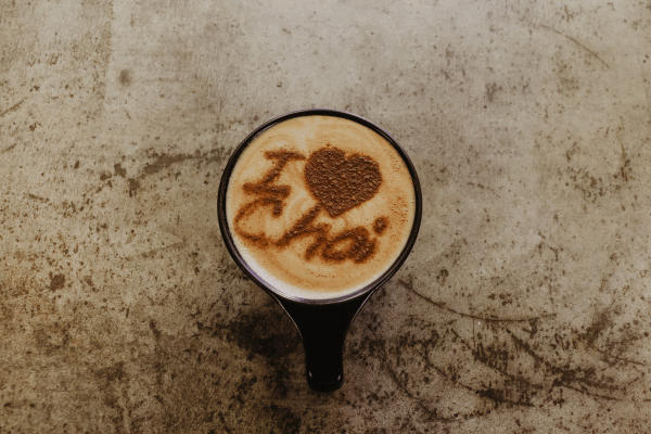 Dutch Bros Chai Drinks vs Competitors: Who Wins? 13 A cup of chai with "I ♥ Chai" written in cinnamon or cocoa powder on the frothy surface.