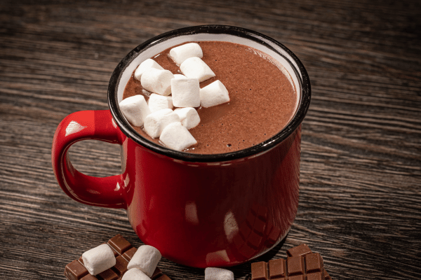 Keto Hot Cocoa: How to Make the Perfect Low-Carb Cup 3 A vibrant red mug filled with rich keto hot cocoa, topped with small, fluffy sugar-free marshmallows.