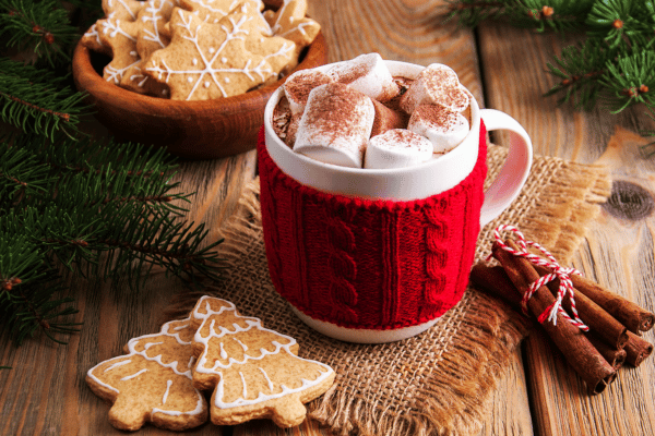 Keto Hot Cocoa: How to Make the Perfect Low-Carb Cup 4 A festive mug adorned with Christmas decorations, filled with creamy keto hot cocoa, topped with marshmallows.
