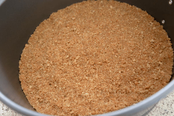 A flattened keto graham cracker dough spread evenly on a baking dish.