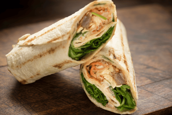 Easy Turkey Wrap Recipe for a Healthy Lunch in Minutes 3 A beautifully cut turkey wrap, showcasing its fresh layers of ingredients.
