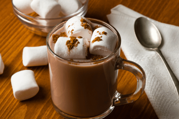 Keto Hot Cocoa: How to Make the Perfect Low-Carb Cup 7 A clear mug showcasing rich, velvety keto hot cocoa, with fluffy, sugar-free marshmallows floating on top. T