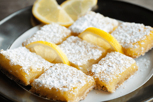 Delicious lemon bars with a tangy, creamy filling sit atop a crisp keto graham cracker crust. 