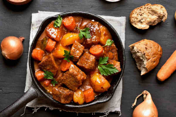 Keto Beef Stew Recipe: Low-Carb Comfort in a Bowl 8 Beef stew in a deep pan with bread and onions
