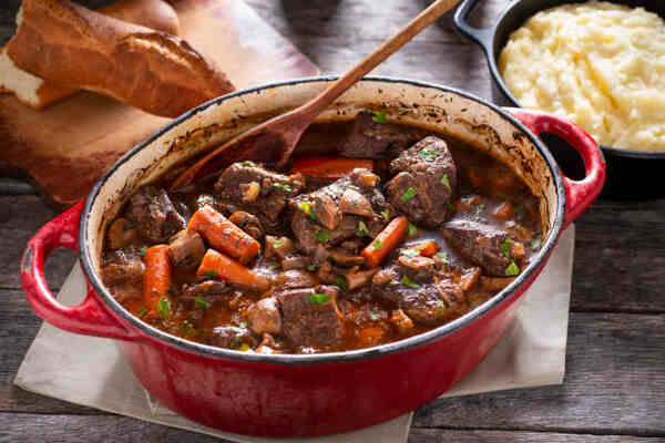 Keto Beef Stew Recipe: Low-Carb Comfort in a Bowl 7 Beef stew in a baking dish served with bread and mashed potatoes