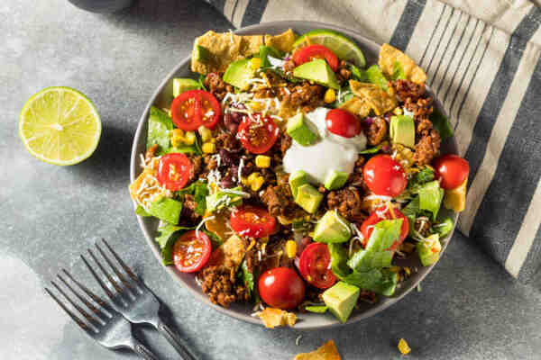Easy Keto Meals That Make Low-Carb Living a Breeze 10 Beef taco salad in a bowl with limes