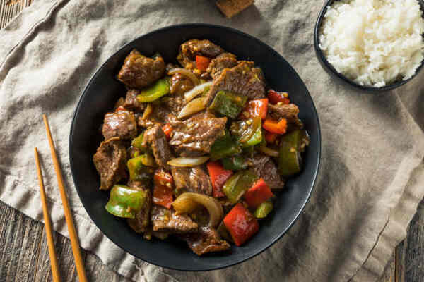 Flavorful Keto Steaks: Easy Recipes for Low-Carb Meals 5 Homemade Chinese pepper steak served with a bowl of rice
