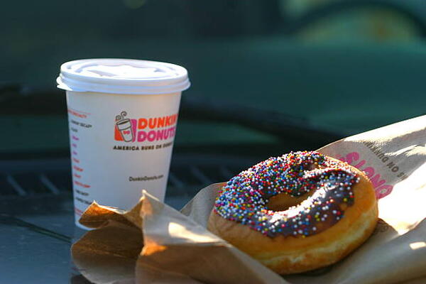 Must-Try Dunkin Sandwiches for a Delicious On-the-Go Meal 8 Dunkin' Donuts coffee and donut from a takeout bag
