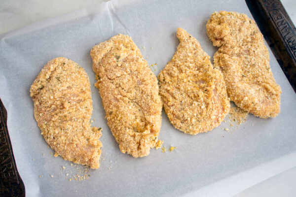 Quick and Easy Aldi Red Bag Chicken Air Fryer Recipe 3 Raw breaded chicken breast fillets on a baking dish