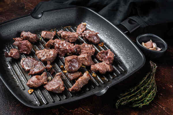 Easy Steak Tips Recipe: Juicy, Tender, and Packed with Flavor 7 Diced beef cooked in a grill pan with garlic and thyme