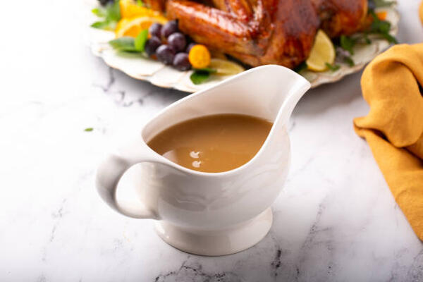 Easy Keto Turkey Gravy Perfect for Your Low-Carb Feast 2 Turkey gravy in a sauce boat with roasted turkey