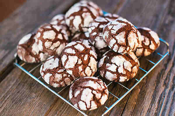 Homemade chocolate crinkle cookies on a wire rack