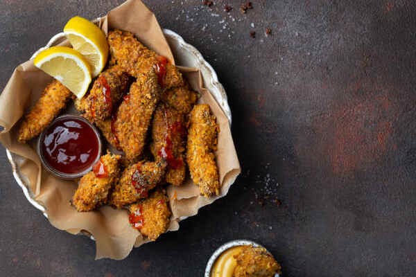 How to Cook Chicken Tenderloins: Easy and Tasty Recipe 7 Fried chicken tenders with dipping sauce and lemon slices