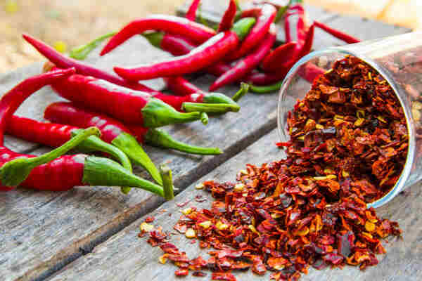 Easy Keto Chili Recipe for a Hearty, Low-Carb Meal 6 Red chili peppers with chili pepper flakes in a container