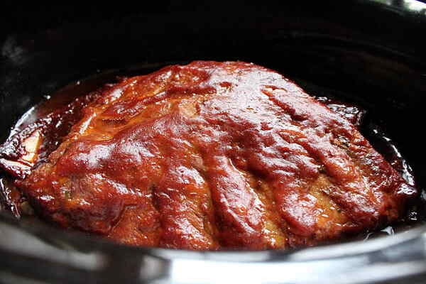 Pork ribs cooked with BBQ sauce in a slow cooker