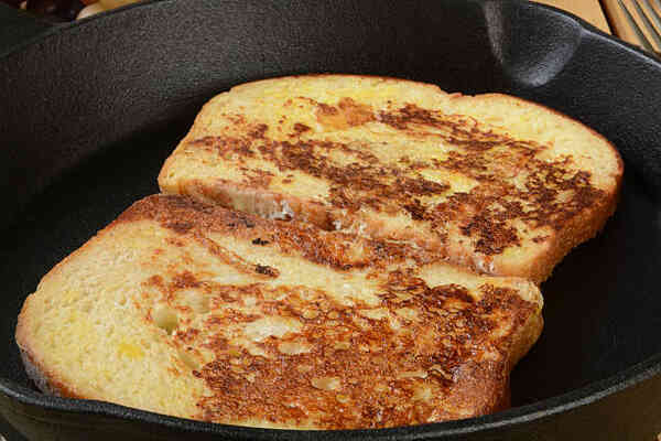 Easy Low-Carb French Toast Recipe for a Keto Breakfast 5 Cooking French toasts on a frying pan