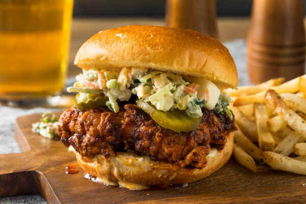 Easy Nashville Hot Chicken Sandwich Recipe You’ll Love 2 A classic Nashville chicken sandwich with pickles and coleslaw served with fries
