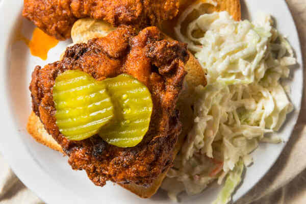 Easy Nashville Hot Chicken Sandwich Recipe You’ll Love 4 Nashville chicken with pickles, coleslaw, and bread