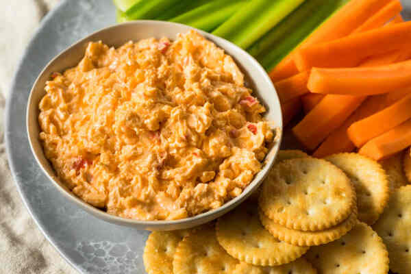 Easy Keto Pimento Cheese Recipe Ready in 10 Minutes 2 Pimento cheese dip served with crackers, carrots, and celery sticks
