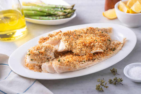 Easy Parmesan Crusted Cod Recipe for a Flavorful Meal 7 Baked breaded fish fillets served with asparagus and lemon wedges