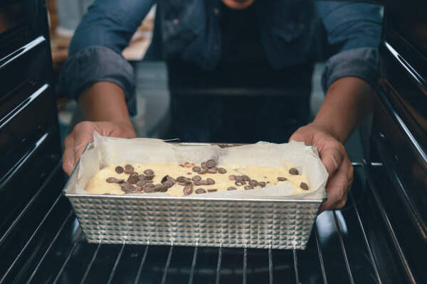 Keto Banana Bread Recipe: Moist, Fluffy, and Low-Carb 5 Putting banana loaf in a pan to bake in an oven