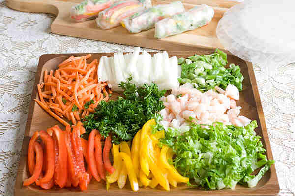 Keto Spring Rolls with Peanut Sauce You’ll Crave Daily 4 Sliced ingredients for spring roll on a wooden tray