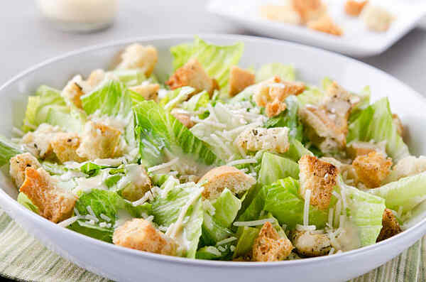Keto Caesar Dressing That's Creamy, Tangy, and Easy 5 Caesar salad served with croutons and cheese on top